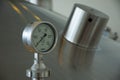 Pressure gauge, close-up. Pressure gauge showing zero bar, attached to beer fermentation tank