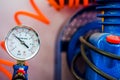 Pressure gauge with orange wire and blue pump