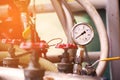 Pressure gauge using measure the pressure in production process. Worker or Operator monitoring oil and gas process by the gauge