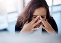 The pressure is getting to her. a young businesswoman looking stressed out while working on a computer in an office. Royalty Free Stock Photo