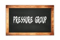 PRESSURE GROUP text written on wooden frame school blackboard