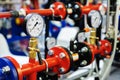 Pressure sensors in the urban heating system. Hot water pipes in an industrial boiler room. Mechanical barometer with arrow to Royalty Free Stock Photo