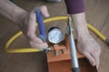 Pressure tester pump is in the hands of a worker