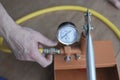 Pressure tester pump is in the hands of a worker