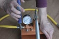 Pressure tester pump is in the hands of a worker