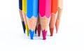 Pressuring bunch of different colored wood pencil on a white paper background Royalty Free Stock Photo