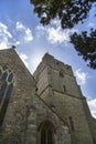 Presteigne church window, tower and yew tree in Powys, Wales.