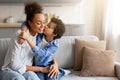 Preteen black son giving his mother loving kiss on the cheek Royalty Free Stock Photo