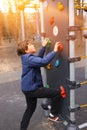 Preteen boy climbing a rock wall outdoors Royalty Free Stock Photo