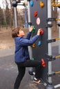 Preteen boy climbing a rock wall outdoors Royalty Free Stock Photo