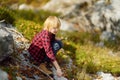 Preteen boy is exploring nature and having fun during hiking in mountains valley on sunny day. Active leisure for energetic Royalty Free Stock Photo