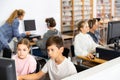 Preteen boy and girl learn to solve problems on computer in school classroom Royalty Free Stock Photo