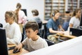 Preteen boy and girl learn to solve problems on computer in school classroom Royalty Free Stock Photo