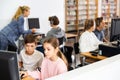 Preteen boy and girl learn to solve problems on computer in school classroom Royalty Free Stock Photo