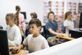 Preteen boy and girl learn to solve problems on computer in school classroom Royalty Free Stock Photo