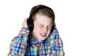 Preteen boy listening to music with headphones and an intense fa Royalty Free Stock Photo