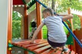 A preteen boy playing on a children`s playground. Royalty Free Stock Photo