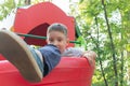 A preteen boy playing on a children`s playground. Royalty Free Stock Photo