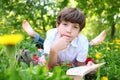 Preteen boy reading book outdoor spring Royalty Free Stock Photo