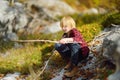 Preteen boy in red shirt is exploring nature and having fun during hiking in mountains valley on sunny day. Active leisure for Royalty Free Stock Photo