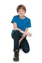 Preteen boy sits on the white background Royalty Free Stock Photo