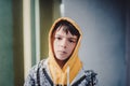 Preteen boy on a street in a big city next to a high-rise building alone. Royalty Free Stock Photo