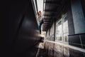 Preteen boy on a street in a big city next to a high-rise building alone. Royalty Free Stock Photo