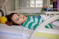 Preteen child, boy, lying in hospital with fractured thoracic spine, vertebralis