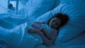 Preteen child sleeping in bedroom at