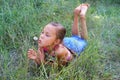Preteen girl blowing on dandelion Royalty Free Stock Photo