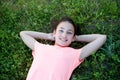 Preteen girl with blue eyes lying on the grass Royalty Free Stock Photo