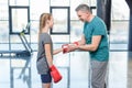 Preteen girl boxing with senior trainer