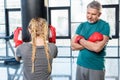 Preteen girl boxing with senior trainer