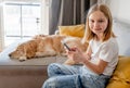 Preteen girl with golden retriever at home Royalty Free Stock Photo