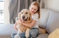 Preteen girl with golden retriever dog at home Royalty Free Stock Photo