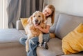 Preteen girl with golden retriever dog at home Royalty Free Stock Photo