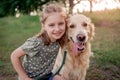Preteen girl with golden retriever dog outdoors Royalty Free Stock Photo