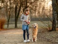 Preteen girl with golden retriever dog Royalty Free Stock Photo