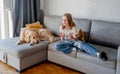 Preteen girl with golden retriever at home Royalty Free Stock Photo