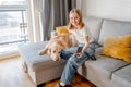 Preteen girl with golden retriever at home Royalty Free Stock Photo