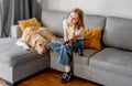 Preteen girl with golden retriever at home Royalty Free Stock Photo