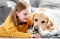 Preteen girl with golden retriever dog Royalty Free Stock Photo