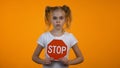 Preteen girl showing stop sign, family misbehavior, children rights protection