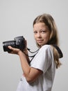 Preteen girl with the slr camera Royalty Free Stock Photo