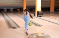 Preteen girl throwing ball at bowling Royalty Free Stock Photo