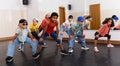 Preteen girls and boys hip hop dancers doing dance workout Royalty Free Stock Photo