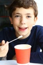 Preteen handsome boy with cappuccino paper glass