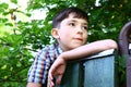 Preteen handsome boy climb village fence