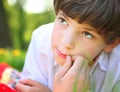 Preteen handsome boy face close up portrait in the summer park