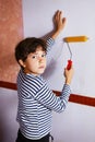 Preteen handsome boy in frock with roll coaster and wallpaper